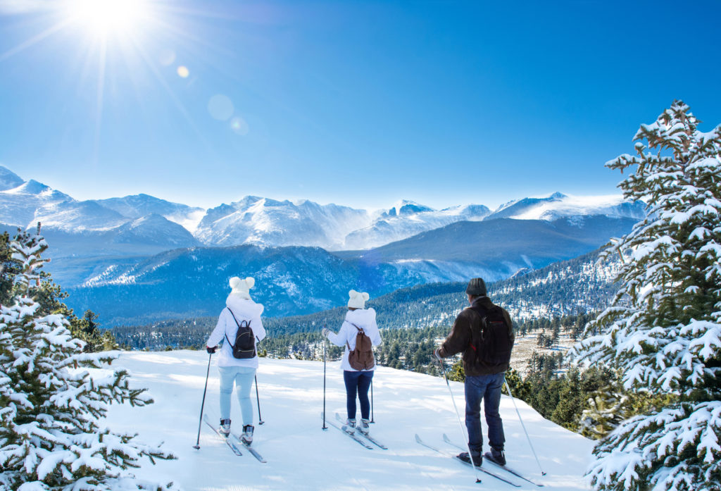 Active family skiing on winter vacation in Colorado
