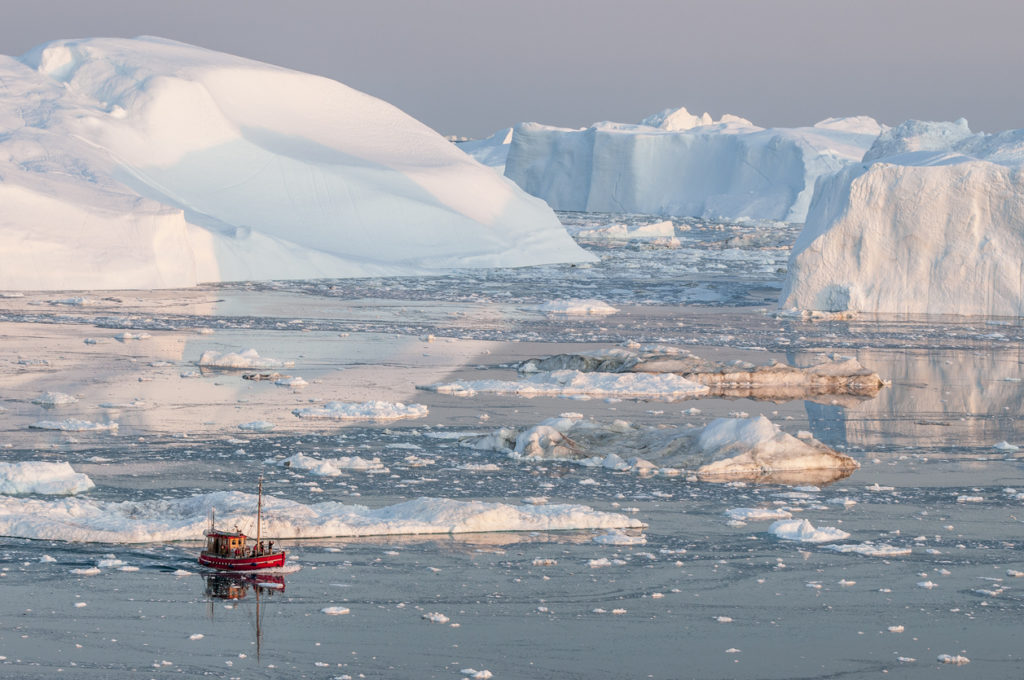 Boat among iceberg in Greenland