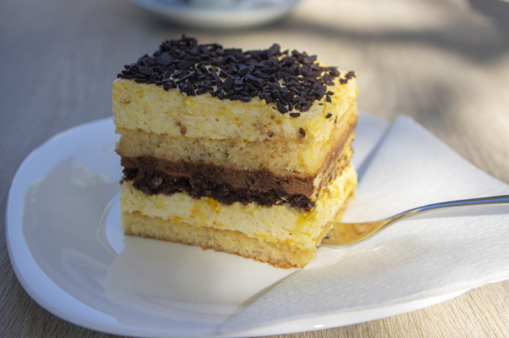 Delicious Slovenian cake on white plate called Izolanka, very tasty dessert with chocolate and orange