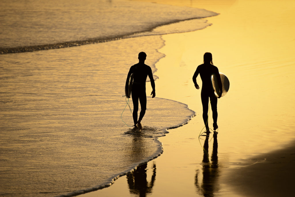 Surfers after a great surf walking back