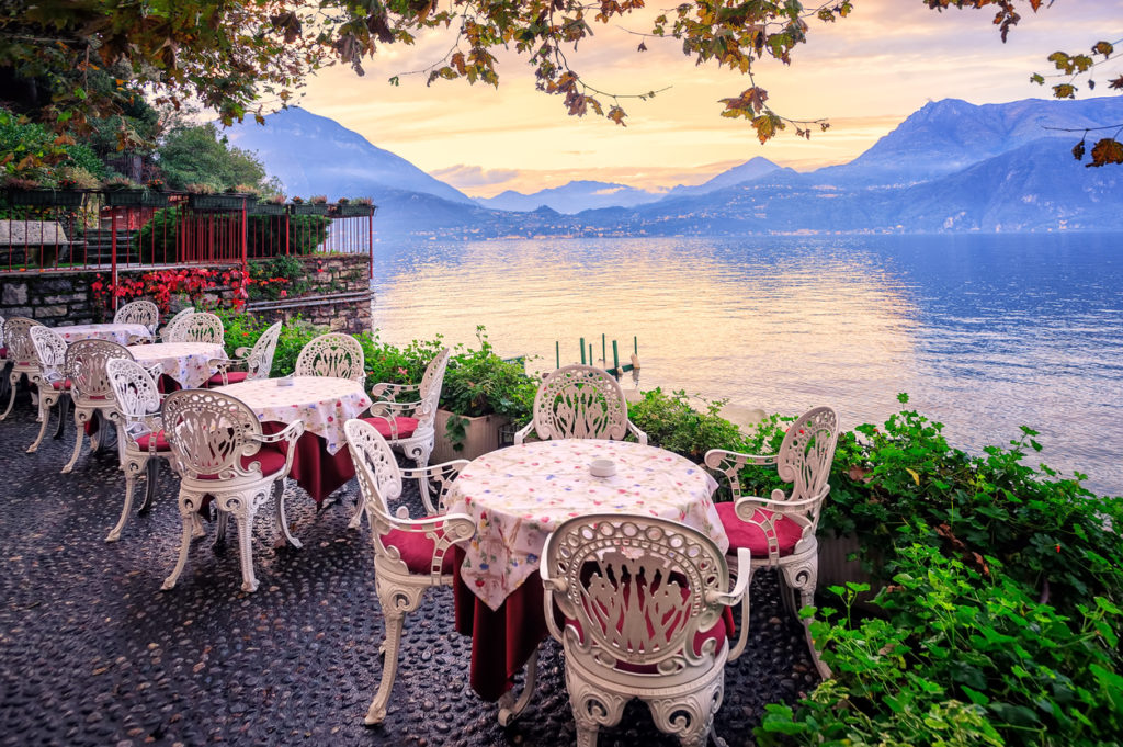 Tables in a small cafe at the waterfront of Lake Como, Italy