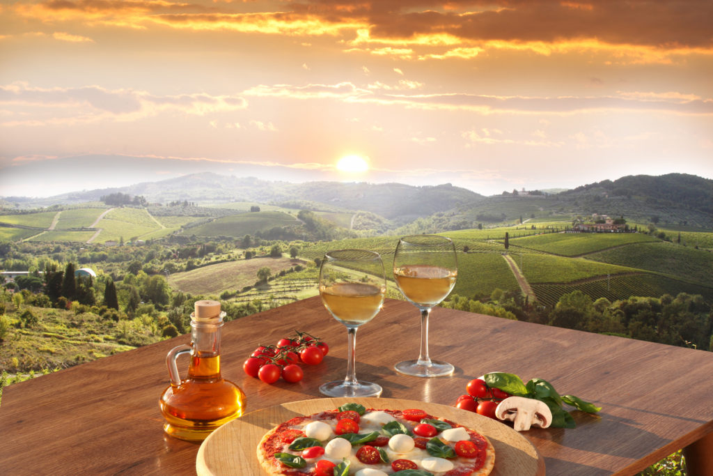 Chianti vineyards with pizza and glasses of white vine