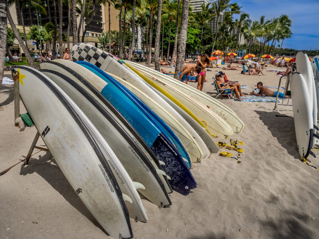 Surfboard rentals waiting for tourists on Waikiki beach