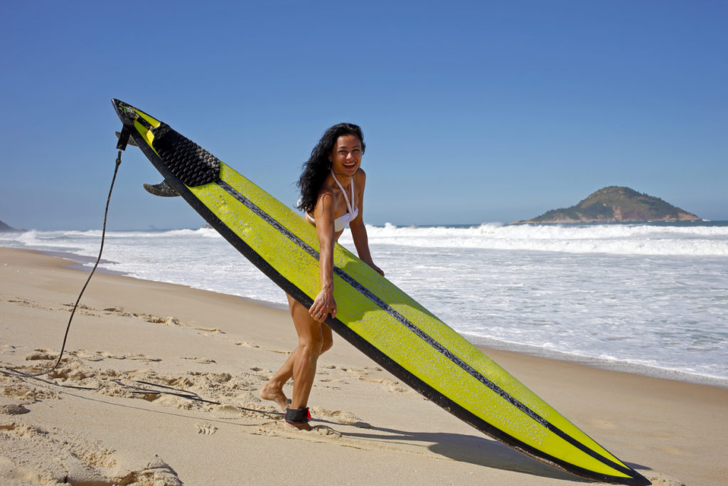 Woman preparing to surf in Rio de Janeiro