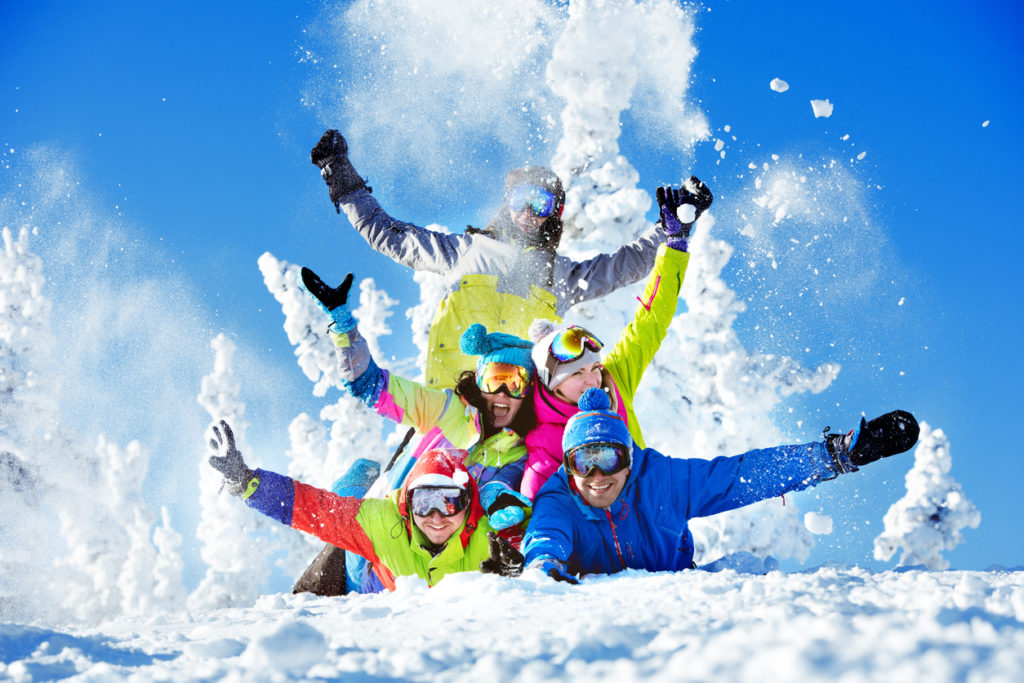 A group of happy friends skiing.