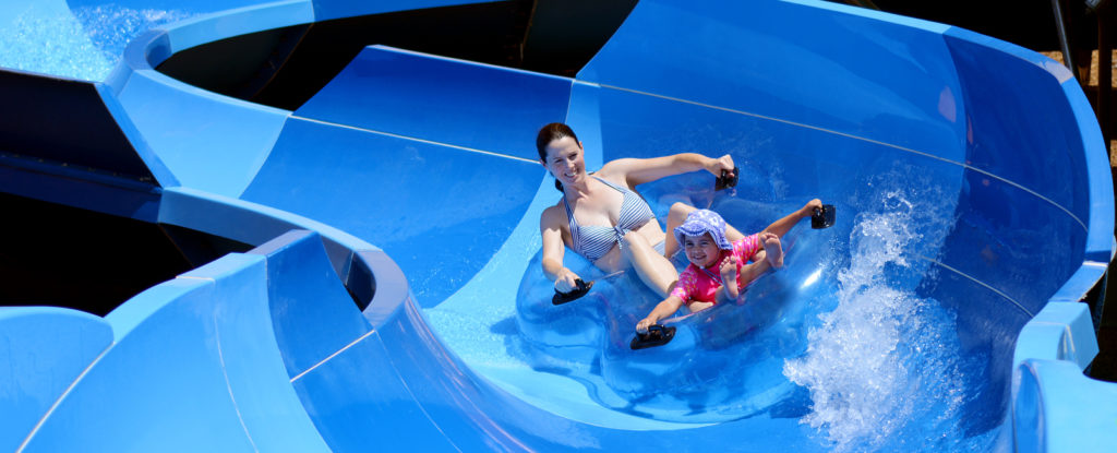 Mother and child having fun on a water slide