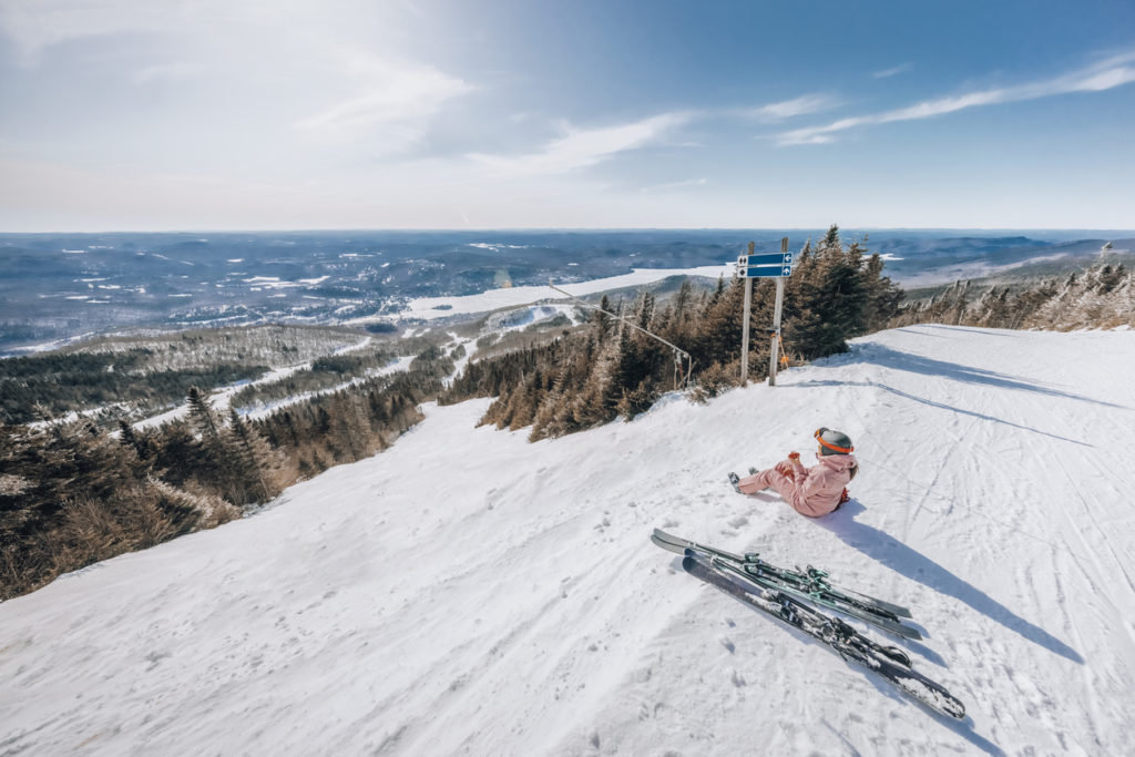 Woman taking a break from skiing on Mont Tremblant, Quebec