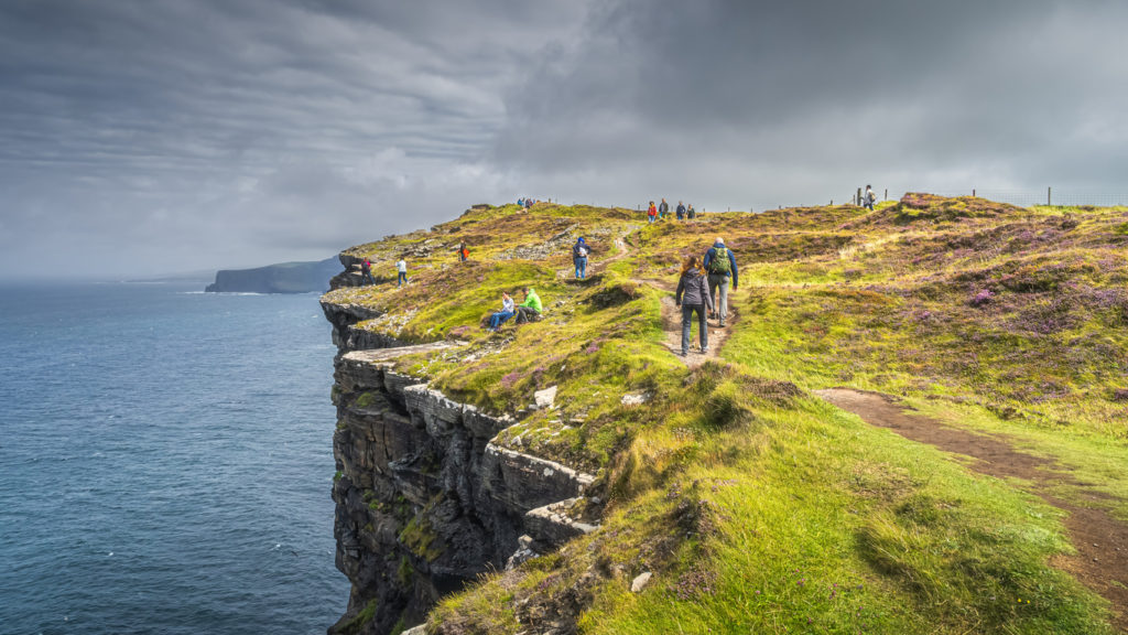A group hiking along the Cliffs of Moher, Ireland.