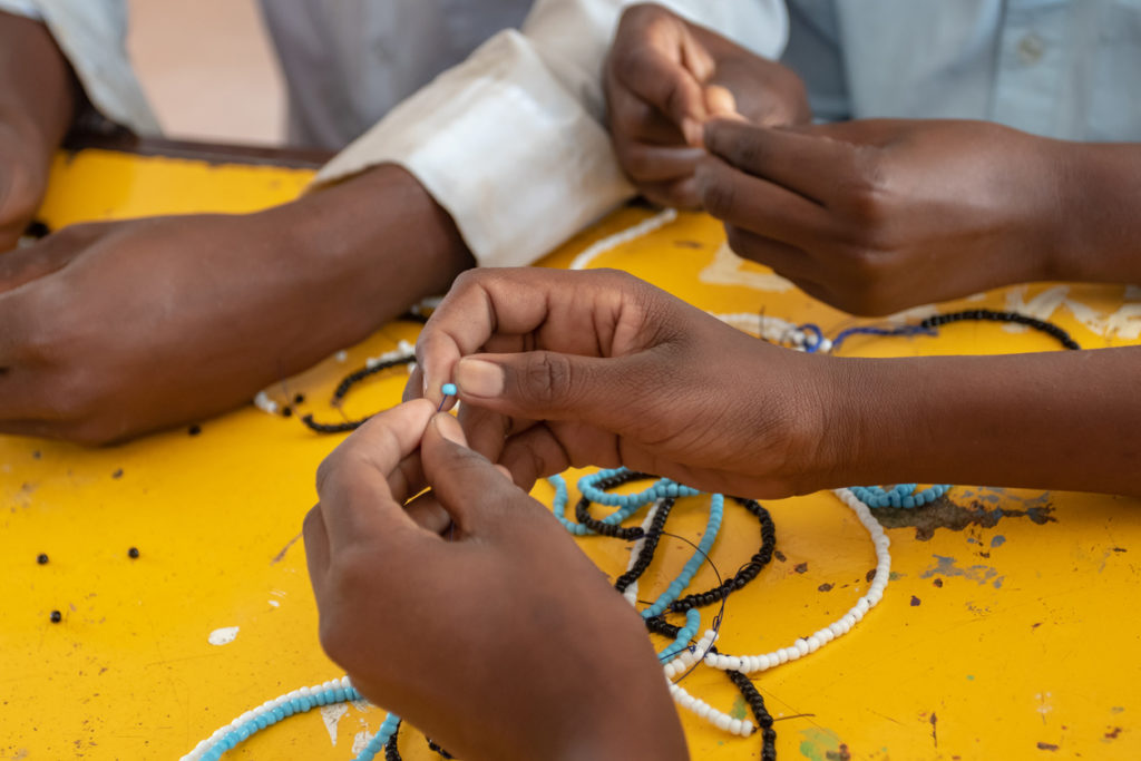 Beadwork being completed in the national colour of Botswana.