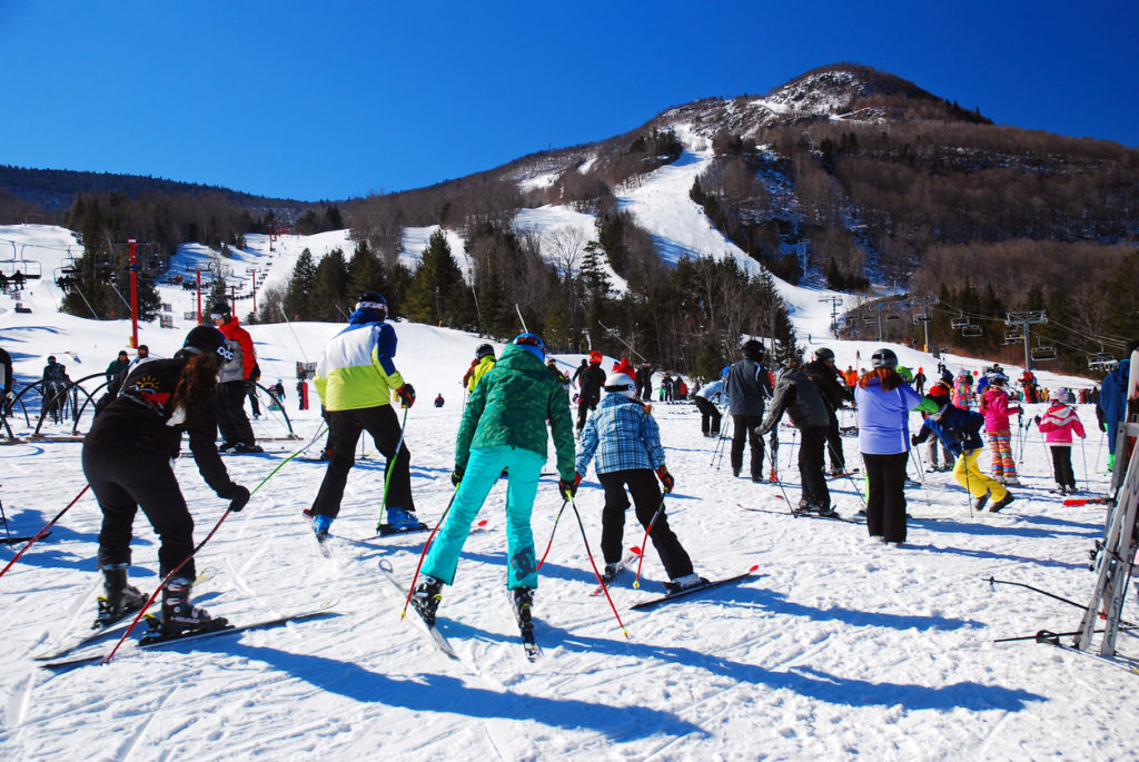 Friends learning to ski in Hunter resort, New York.