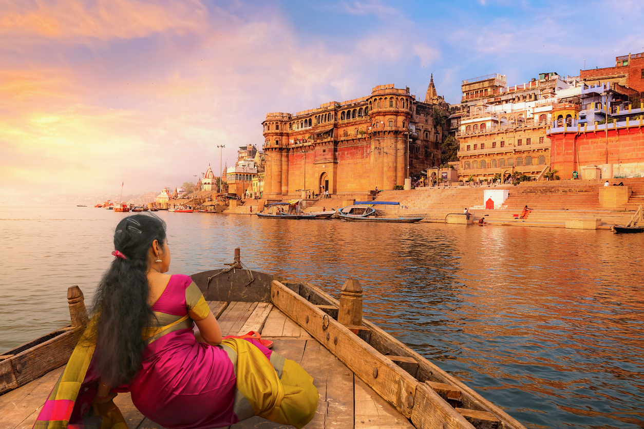 Indian toursit enjoying the the ancient city of Varanasi on the river Ganges at Sunset.