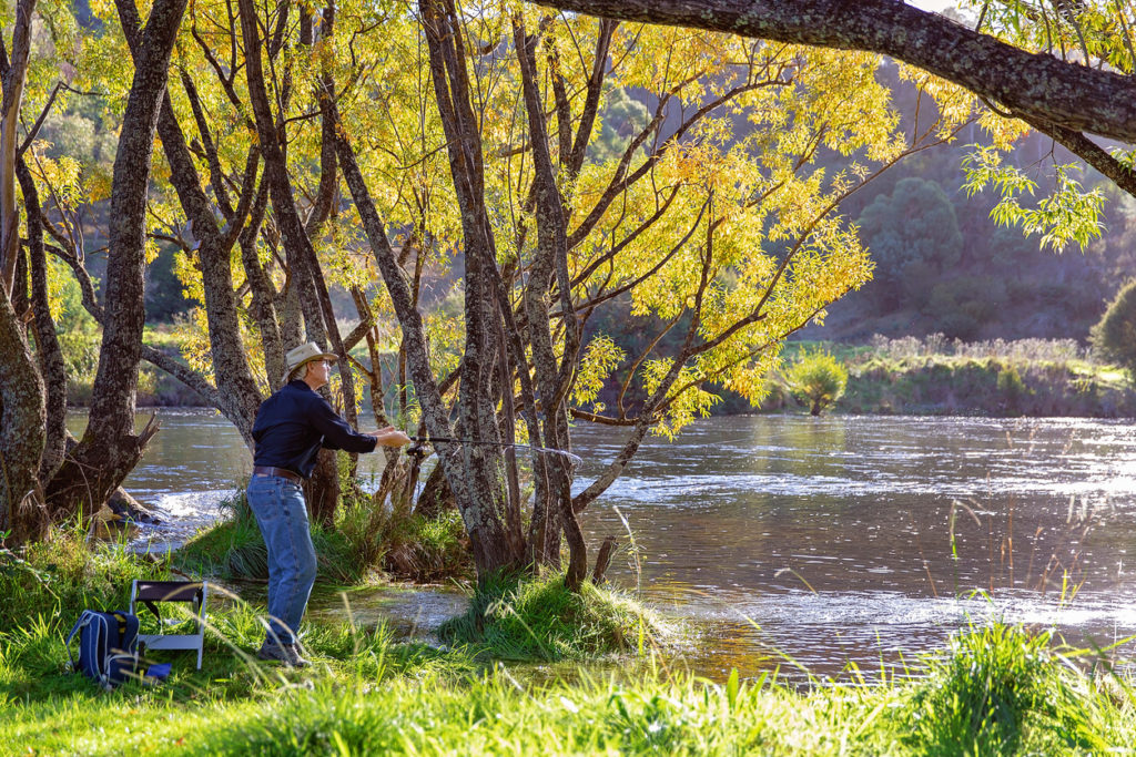Retiree on vacation fishing in the Australian countryside.