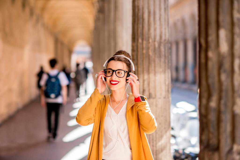 Student in the famous arched galleries in Bologna city, Italy.