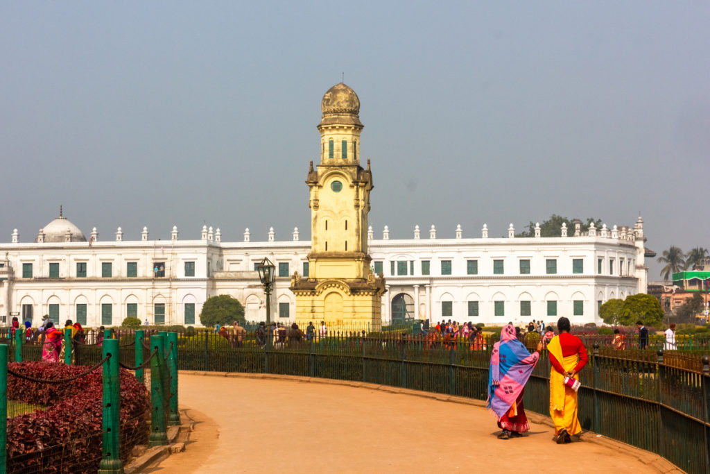 The old clock towers in the ground of Hazarduari Palace ground with the Nizamat Imamabara in the background, Murshidabad, West Bengal.