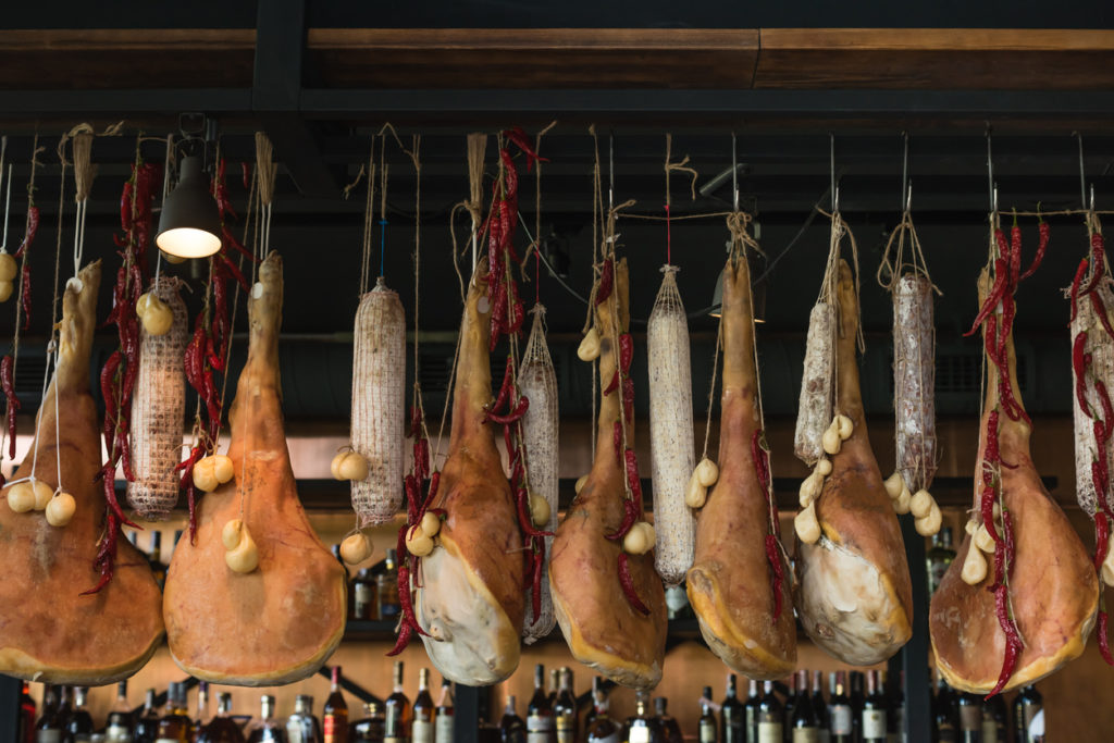 Dry and salty jamon legs hanging on a bar counter