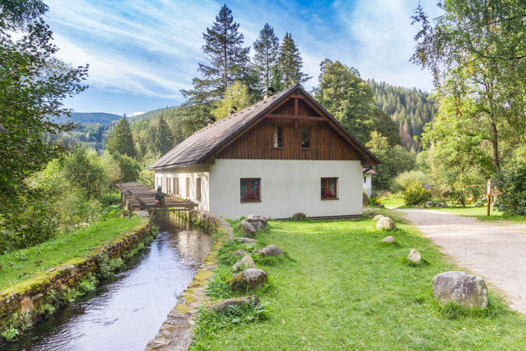 Traditional cottage in the landscape of the Sumava mountains