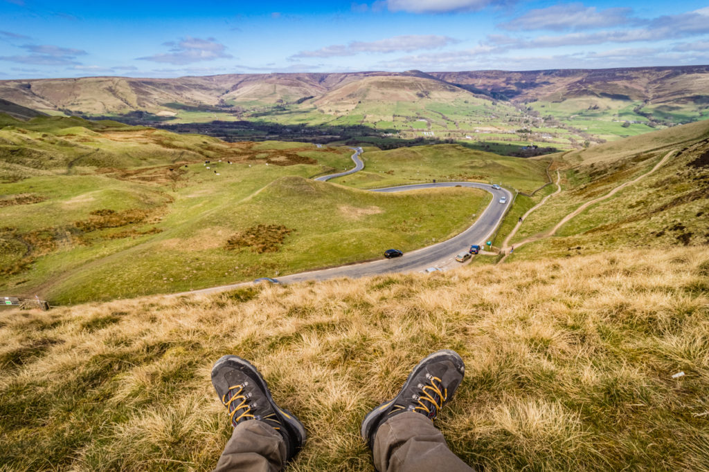 Hiker hiking from Man Tor to Losehill Pike Wards Piece, Peak Dsitrict.