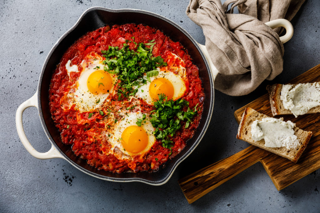 Breakfast Shakshuka fried eggs with tomatoes and cheese.