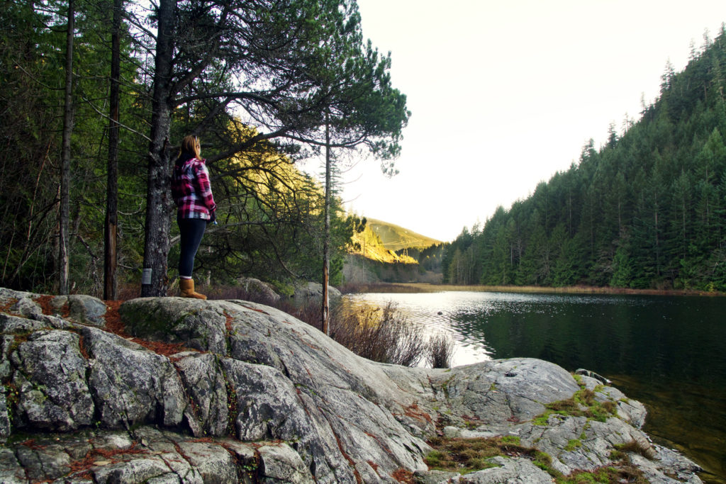 Female hiker visiting Brohm Lake near Whistler, Canada.