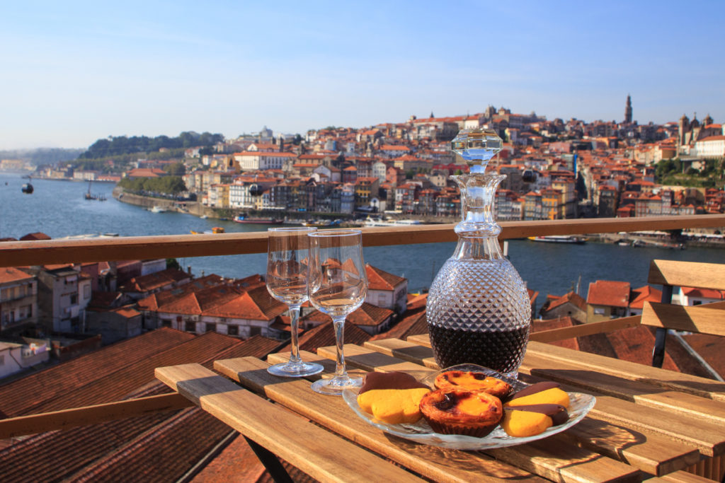 Table with port wine overlooking the river in Porto, Portugal.