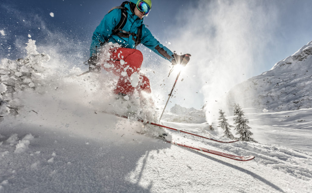 Man freerider skier running downhill