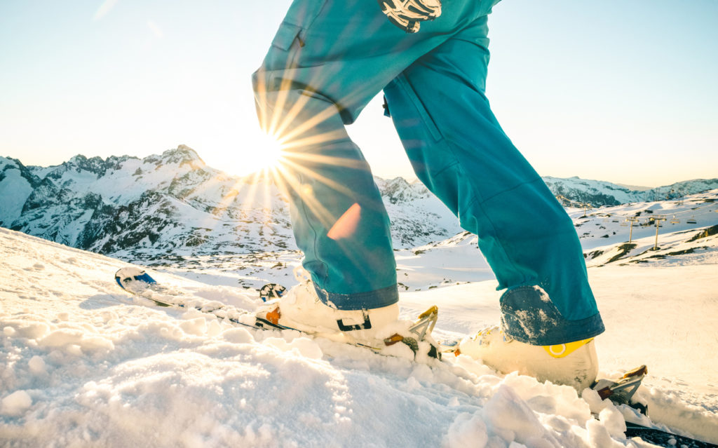 Skier on a mountain at sunset
