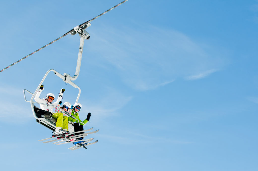 Happy skiers on a ski lift