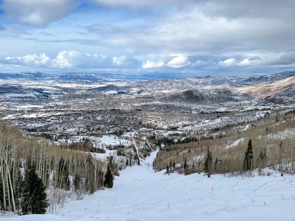 View of Rocky Mountains and a ski run at Snowmass ski resort