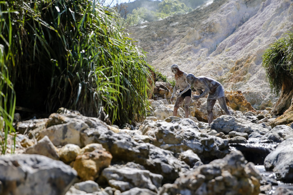 People enjoying the hot springs and natural mud baths at Soufriere at St Lucia