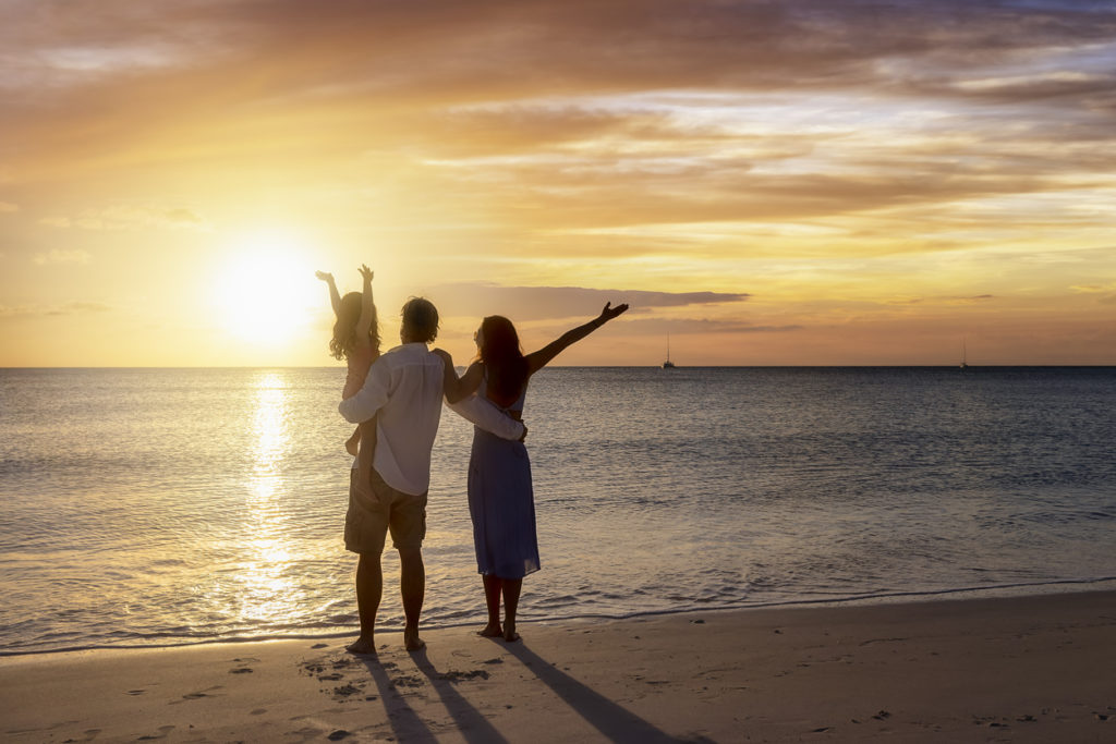 Family on the beach at sunset