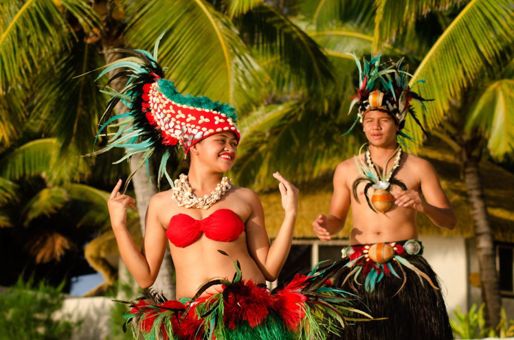 Male and female Polynesians dancing