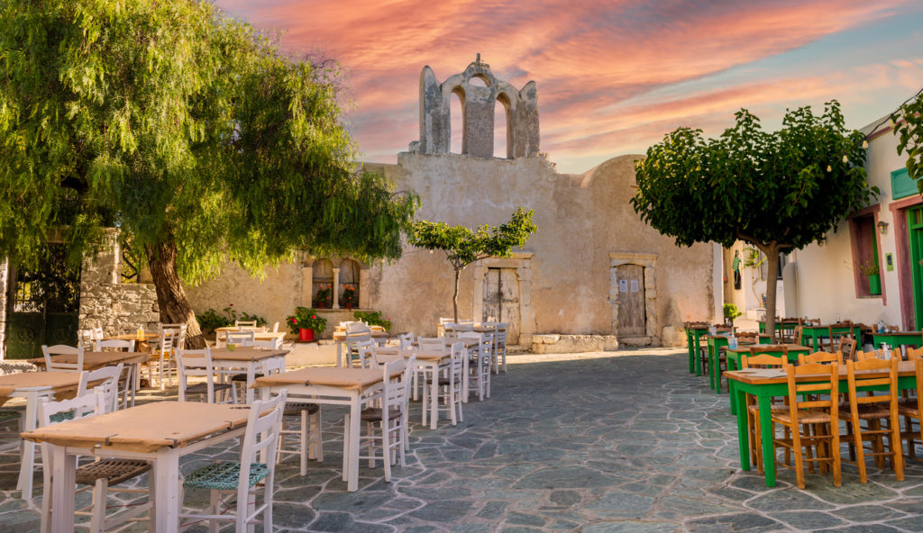 A square with the backdrop of an old church building in Chora town, Folegandros Island