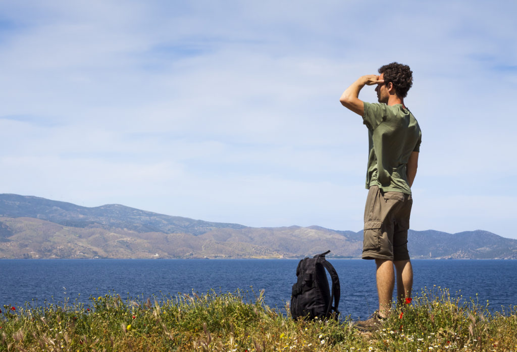 Hiker enjoying the view of the sea from Hydra Island