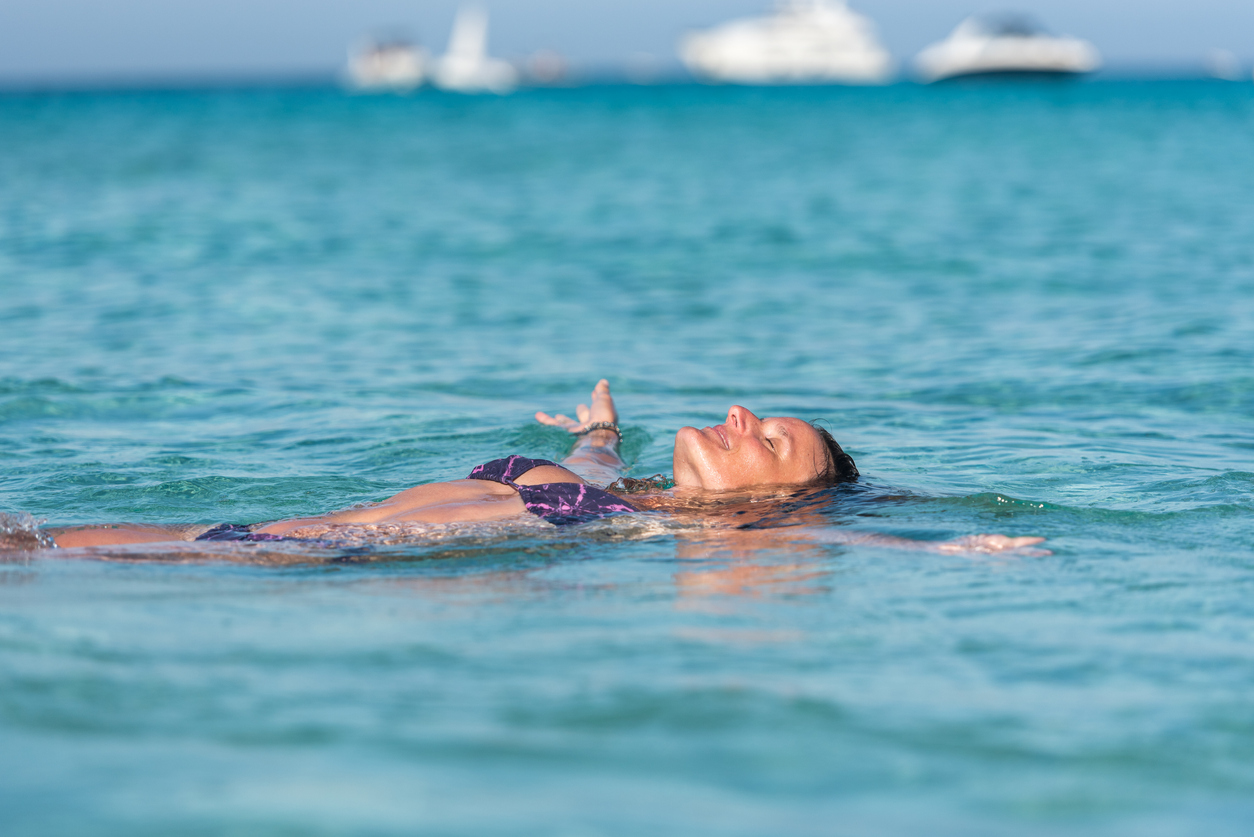 Lady floating on her back in Levante, Formentera