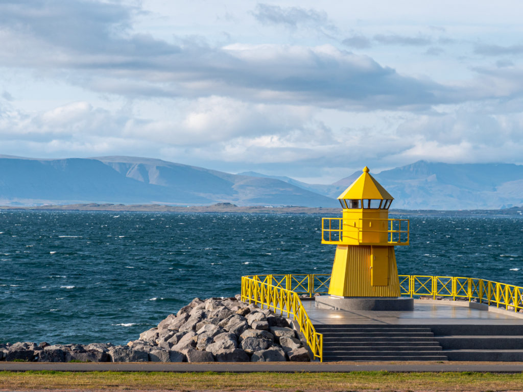 Yellow lighthouse at entrance to Reykjavik port