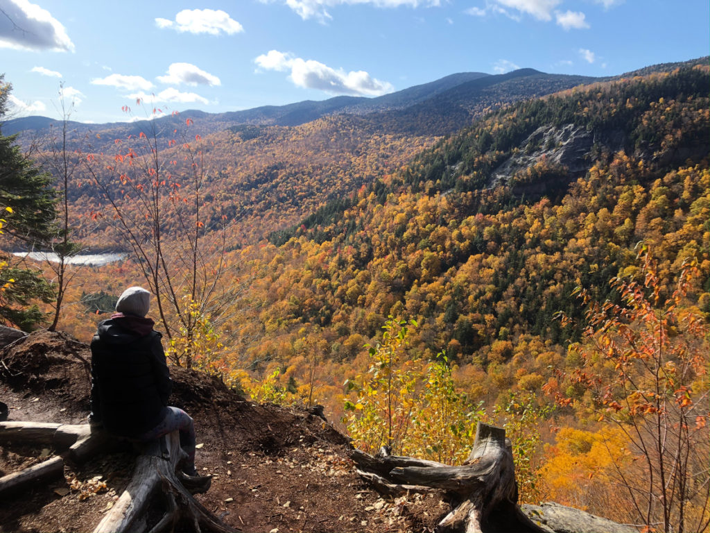 Taking a break from hiking overloojing the mountain valley of Nebraska Notch