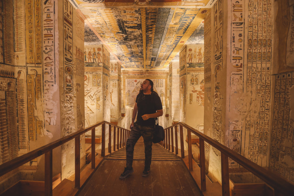 Tourist admiring the hieroglyphics in one of the tombs in the Valley of the Kings